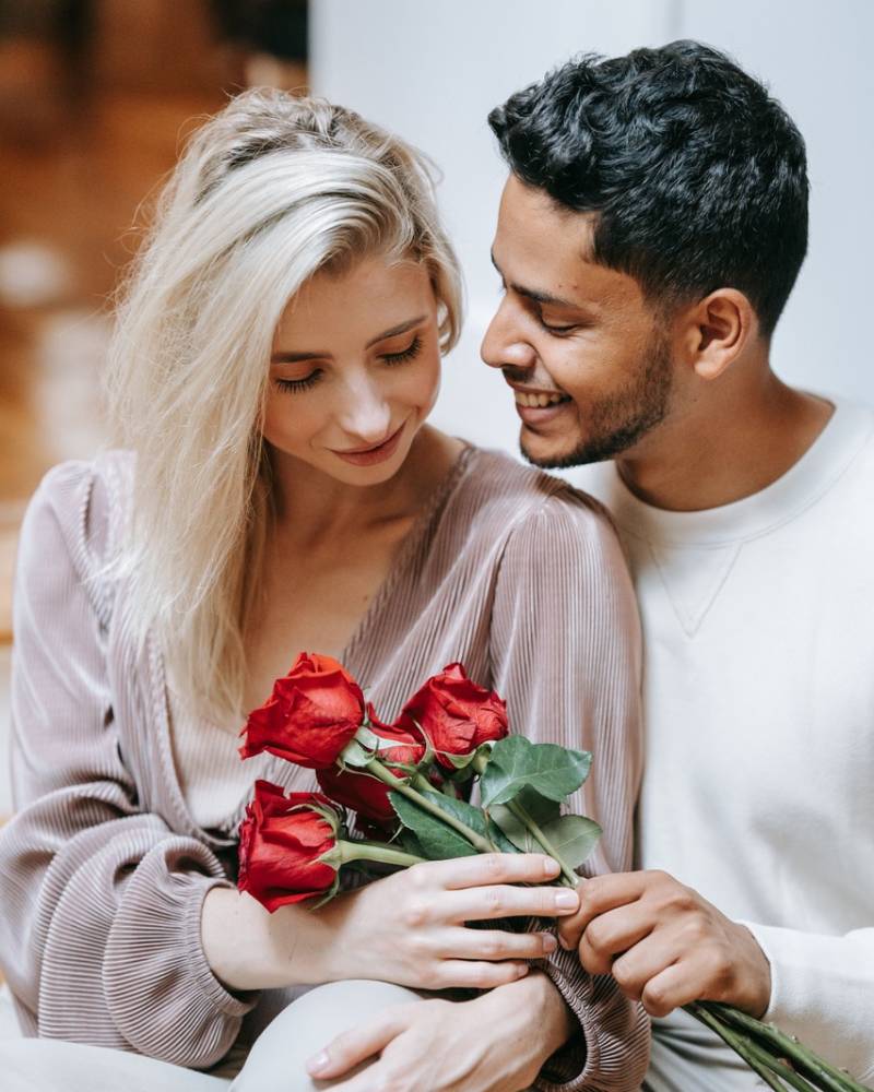 Un homme qui offre des roses à sa compagne
